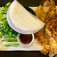 Vegan banh xeo. Vietnamese crispy crepe made from rice flour, coconut milk and turmeric, filled with bean sprouts and tofu. Accompanied by rice paper, herbs and sauce for wraps.  at Mimi Nguyen Cafe in Puchong