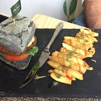 Home-made burger on charcoal bread bun with fries - so good!  at The Vegvolution Kitchen in Hong Kong Island