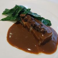 The main: kohlrabi and eggplant slice topped with a flavorful gravy, kalamata olives, and greens at Gauthier Soho in London