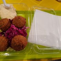 The falafels with hummus, and salad underneath at Hummus Bar in Belgrade