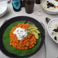 Curry served with rice and a sauce at Gaudi&Naan in Ljubljana
