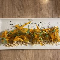 Cured bell pepper filled with cream and topped with crispy carrot or potato  at Gaudi&Naan in Ljubljana