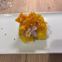 Tangy yellow peppers wrapped around cream cheese with parsnip(?) crisps and black sesame seeds at Gaudi&Naan in Ljubljana
