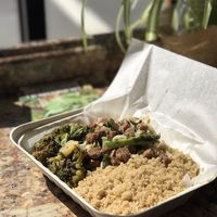 A regular sized box with cous cous, kale, and soya mix at Oasis Vegan Veggie Parlor in Dorchester