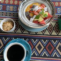 Mango smoothie bowl and black coffee  at Nook Eatery in Hue