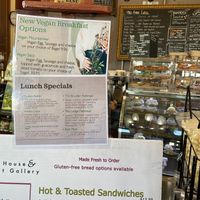 Menu showing new vegan breakfast options and display case featuring vegan pastries and donuts.  at The Met Coffee House and Art Gallery in North Conway