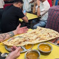 Giant naan, arm sized and wouldn't even fit on the table! at Kake di Hatti in New Delhi