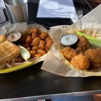 (left) Bahn Mi [in exile] with tater tots and Yum Yum Sauce (right) 1/2 order Buffalo Cauliflower Wings  at Detroit Street Filling Station in Ann Arbor