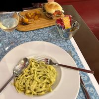 Vegan burger and patatas, non-vegan pesto noodles (cheese and egg) at El Astronauta in Cordoba