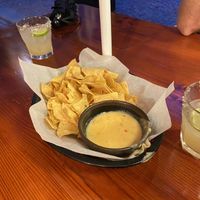 Nachos with cheese dip and margarita in the background  at Geronimo's FGT   in Stockholm