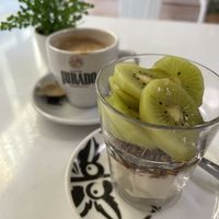 Yoghurt, granola & fruit bowl with oat milk coffee  at Vegan Bombon in Alicante