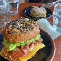 Breakfast bagel + what’s left of our lemon cinnamon roll   at Bite Me Cafe in Madrid