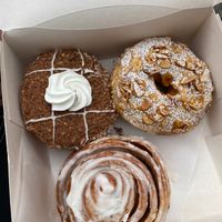 speculoos cream doughnuts, marzipan ring dougnut and a cinnamon roll at Bite Me Cafe in Madrid