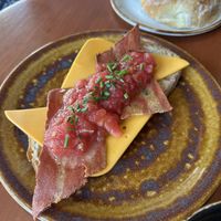 Tostada con tomate, queso y vacon   at Bite Me Cafe in Madrid