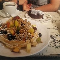 Vegan chocolate cake, capuccino with soy milk, vegetarian breakfast (waffle with lots of fruits!) and vegetarian latte. at Amelie Cafe & Dekoration in Saarlouis