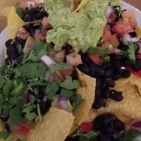 PadreRitaGrill Nachos, veganized. The refried beans are not vegan so unless you want lard, go with the black beans. at PadreRitaGrill in South Padre Island