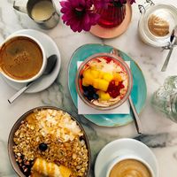 Left: Acai Bowl with banana, coconut and granola and peanut butter on top. Right: Tropical Chia pudding. Both 100% vegan! at Paledo in Hamburg