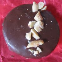 A vegan alfajor. Two cookies with homemade peanut butter and raspberry jam in between, coated with chocolate.  at Ranita Lilo Reposteria Vegana in Valparaiso