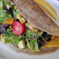 rice pancake with smoked cashew cheese, avocado, green leaves and tomatoes at Cafe Parallel 43 in Sofia