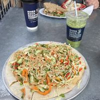 My Phuket pizza and oatmilk matcha latte (with brown sugar cinnamon syrup) and my partner’s chickpea salad sandwich and oatmilk coffee latte  at River Rock Roasting Company in La Verkin