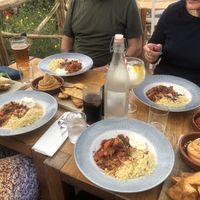 Wider table shot showing drinks and patatas bravas type dish to the far right  at Eden Project in St Austell