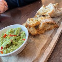 Avocado with garlic bread  at Wulf & Lamb Chelsea in London