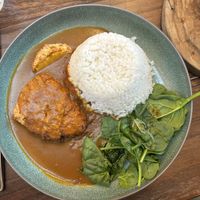 Katsu curry - barely any sauce and wilted spinach on the sidee  at Wulf & Lamb Chelsea in London