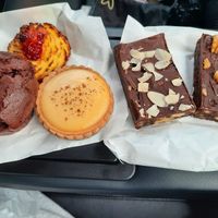 Chocolate muffin, coconut biscuit, custard tart, almond slice and walnut slice(left to right) at La Panella in Preston