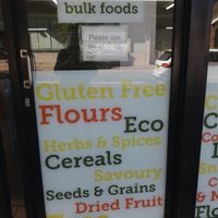 Signage on window at Village Wholefoods & Bulk Foods in Marrickville