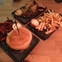 Green Oatburger, Sweet potato fries, French fries and bread with different toppings. at Backstage Vegan Kitchen in Rotterdam