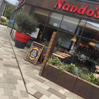 Outside with outside seating at Nando's in Gillingham