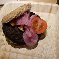 Burger with toppings including pickled onions at CPH - 42°Raw - T2 in Copenhagen