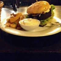 seitan burger with potato fries at Tři Ocásci in Brno