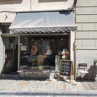 front: two tables with some chairs on pavement at Charlotte's by De Brugsche Tafel in Bruges