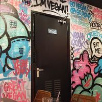 Inside decor; graffiti wall at Vegan Junk Food Bar - De Pijp in Amsterdam