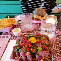Loaded fries, a burger and a side of fries at Vegan Junk Food Bar - De Pijp in Amsterdam