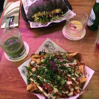 loaded fries + hot dog in a black croissant, how rad is that?! at Vegan Junk Food Bar - De Pijp in Amsterdam