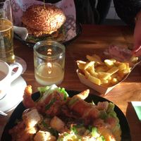 Shrimp salad, cheese burger, fries, coffee, and beer. at Vegan Junk Food Bar - De Pijp in Amsterdam