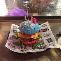 Burger with vegan chicken, cheese, bacon, lettuce, tomato and pickles.  at Vegan Junk Food Bar - De Pijp in Amsterdam