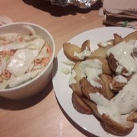 Potato wedges with dill sauce and coleslaw at Krowarzywa in Gdansk