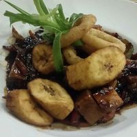 Jackfruit, Pineapple, Sweet Potato , Peppers stir fry in a soya and black bean sauce  with Plantain and Onion rings at Kool Runnings in Inverness