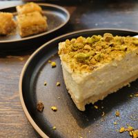 Baklava in background (all vegan, walnut, peanut and cashew (?) Flavour) and vegan pistachio cheesecake at Marrakech Artisan in Hastings