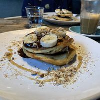 Plant-based pancakes with nuts, dark choc sauce and banana at The Old Bicycle Shop in Cambridge