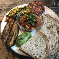 Vegan breakfast with tofu scramble, smoky bean stew, miso eggplant, avocado, roasted tomato, and sourdough bread.  at The Old Bicycle Shop in Cambridge