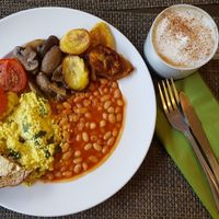 Cooked breakfast with an oat milk cappuccino  at Plantbase Cafe in South West London