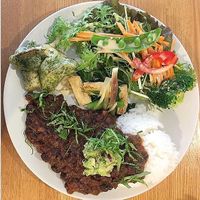 black bean stew with mash avocado and red onion sauce, eringi mushrooms fritters, katsuona leaf, deep fried tofu and japanese ginger in vegan dashi broth, fresh salad and rice at Kuppila in Nara