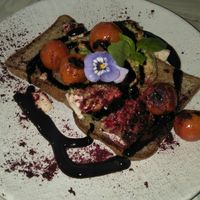 smashed avo, with cooked tomato and balsamic sauce at Nature Cafe/Bar in Frankston