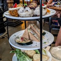 Lettuce wraps and scones on bottom, dill and cream cheese sandwich in the middle, and carrot cake, rice pudding, and cobbler on top. at Boulder Dushanbe Teahouse in Boulder