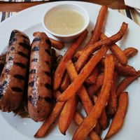 Sausages with apple sauce, sour cabbage and sweet potato fries at Coogi's Restaurant in Mdina