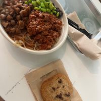 My meal: regular build your own bowl with edamame boost, vegan chorizo, vegan chickpea medley, and a base of sweet potato noodles and quinoa. Vegan chocolate chip cookie on side at Vale Food in Gainesville